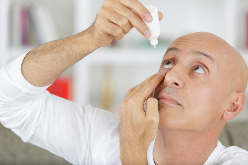 Man Applying Eye Drops